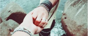 holding hands next to water